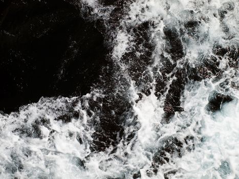 Abstract image showing trail of foam and surf on side of a speeding ship