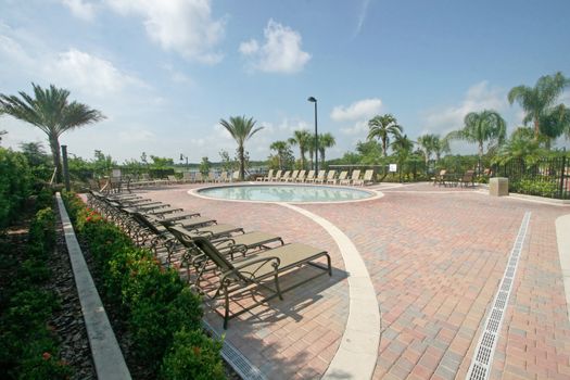 A Small Pool for Children with Chairs around.