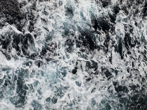 Abstract image showing trail of foam and surf on side of a speeding ship