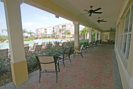 A Pool Veranda with Chairs overlooking Swimming Pool