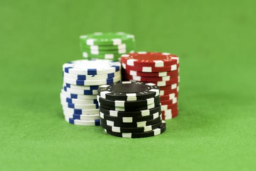 poker chips on green carpet