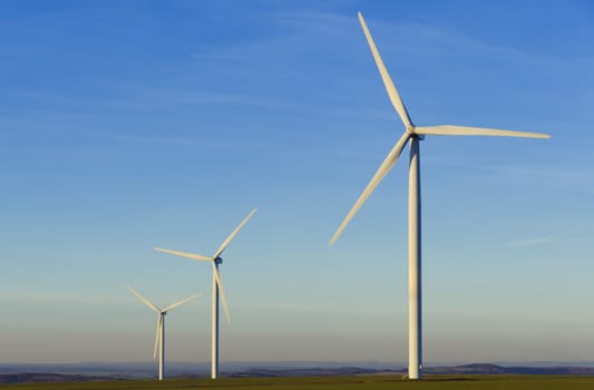 three windmills in the countryside