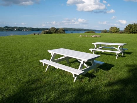 Perfect outdoors picnic setting with white tables 