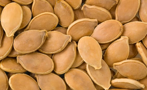 Macro shot of a group of pumpkin seeds.