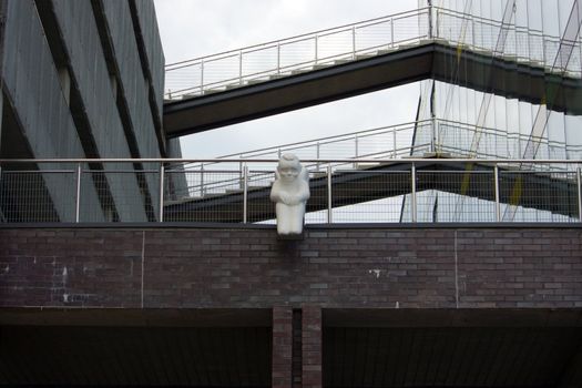 The white angel sits on the brink of a building roof