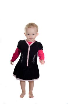 Shot of standing toddler in studio in black dress