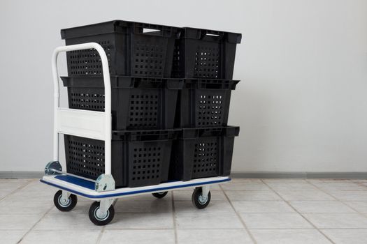 Industial warehouse cart with the stack of empty conainers