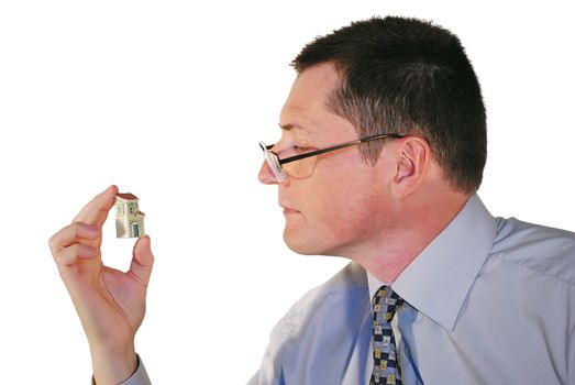 portrait of man in glasses with a toy house