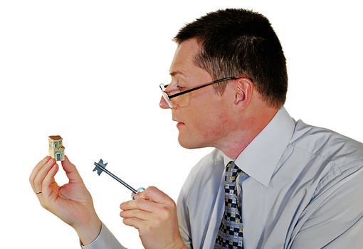 portrait of man in glasses with a toy house and key