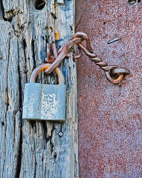 ferruginous hanging lock on the neglected gate