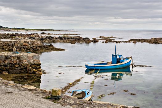 A boat tied up on the edge of Galway Bay, Ireland.