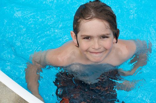 a boy smiling in swimming pool