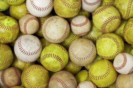 a picture of old softballs and baseballs