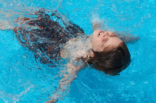 a boy playing in swimming pool