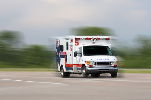 ambulance in motion driving down road