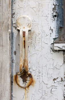 old rusty door handle on aged wood