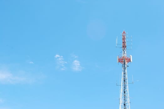 photo of a communication tower against blue sky background