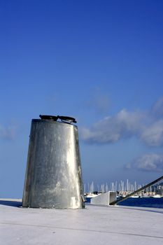 Boat stainless steel oval chimney over blue sunny sky