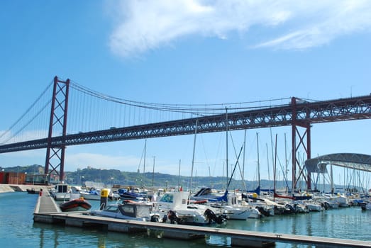 Abril 25th Bridge over river Tagus in Lisbon and local marine