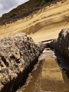 Image shot through rut carved in stone giving impression of a valley