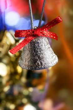 Silver bell in the christmas tree with red ribbon, xtmas card