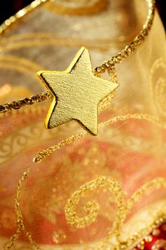 Christmas golden decoration with gold star over red background