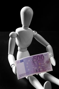 Wooden mannequin with euros bank note, black background