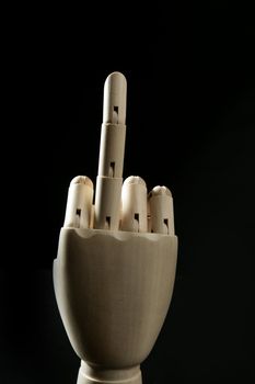 Dirty expression with middle finger up in wooden mannequin hand