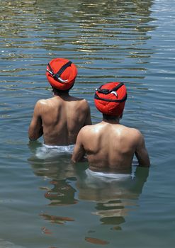 Sikh men bathing in the holy pool at the Golden Temple, Amritsar