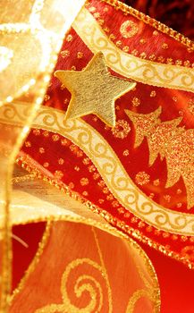 Christmas golden decoration with gold star over red background