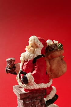 Santa Claus figurine over red background, studio shot