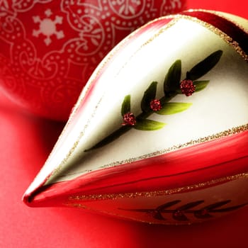 Golden christmas macro decoration, red background, studio shot