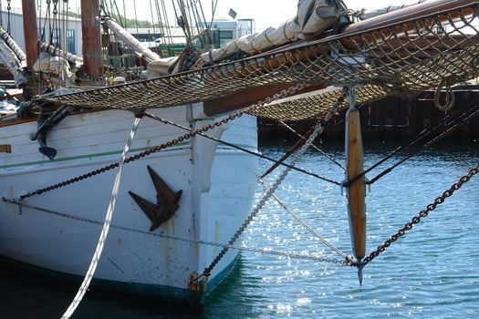 Old vintage wooden sail boat in frontal view marine background