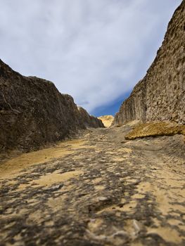 Image shot through rut carved in stone giving impression of a valley