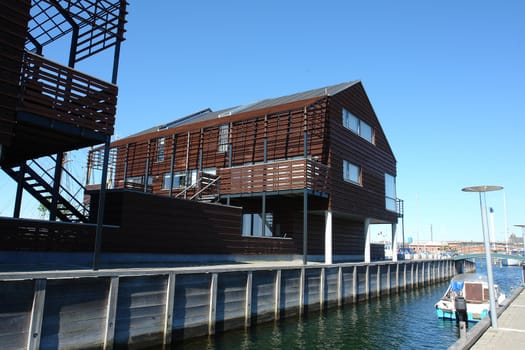 Modern design wooden house over a sea water canal Denmark