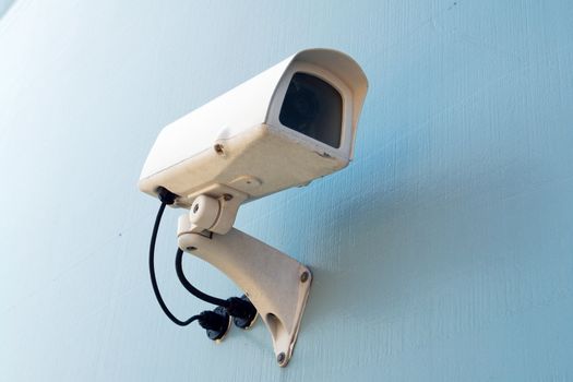 Security surveillance camera on a white wall Big Brother