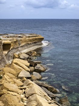 Detail from the coastline showing fallen rocks in Gozo in Malta