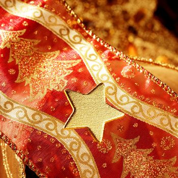 Christmas golden decoration with gold star over red background