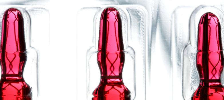 Glass ampoule with red liquid medicine inside