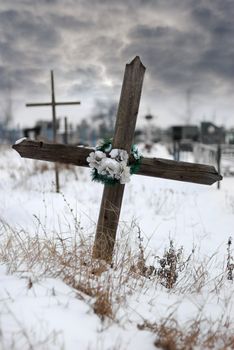 Cross on a cemetery. The drama sky on a background