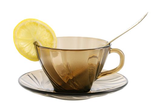 Glass transparent cup with spoon  and lemon. Heat-tolerant utensils 