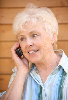 The elderly woman speaks by phone
