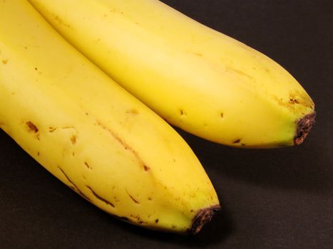Bananas over black background-Natural,imperfect look.       