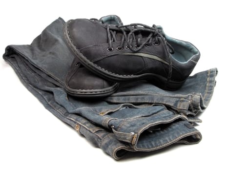 Sports shoes and blue jeans over white background          