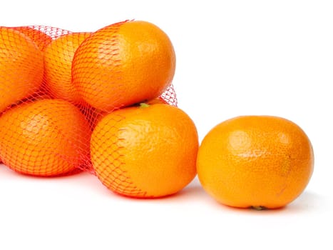 Mandarines getting out from a broken net bag-over white background          