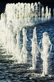 Row of water jets in a urban fountain