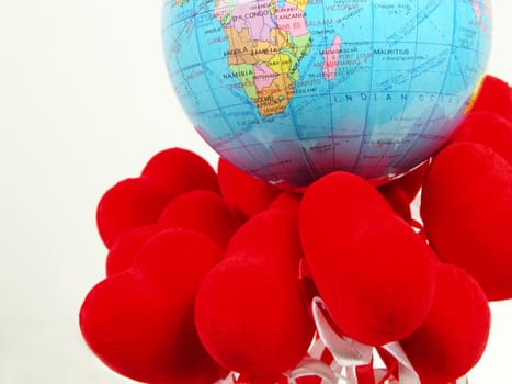 Earth globe on the red hearts          