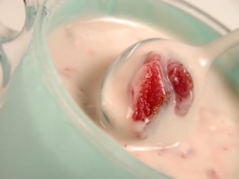 Spoon in strawberry yogurt-close-up          