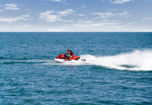 The hairless man on a water motorcycle. Greater speed and effective sparks of water