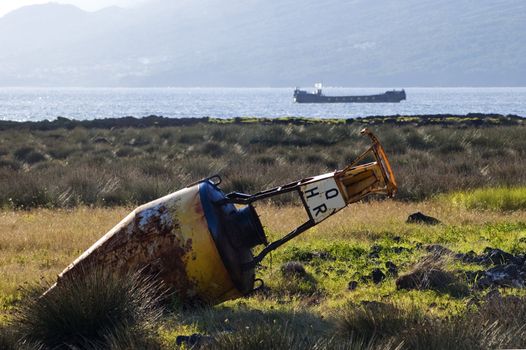 Old beacon buoy on the shore